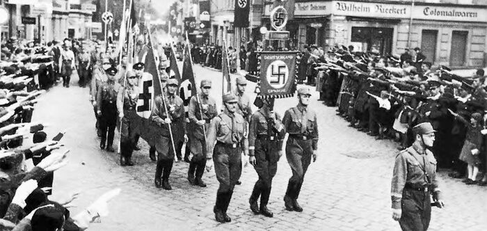 Brown-shirt stormtroopers of the Sturmabteilung ("Storm Detachment, SA") march by Lustnauer Tor in 1933. 